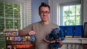 Image of Isaac Childres with his game Gloomhaven