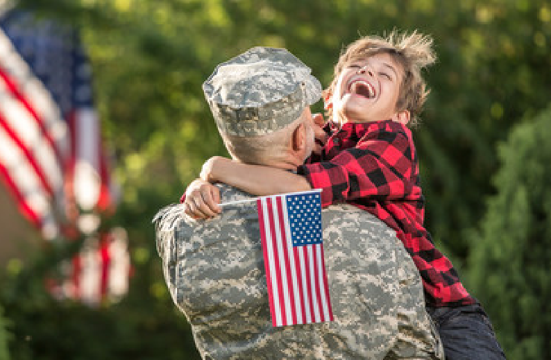 Military member holding their happy child